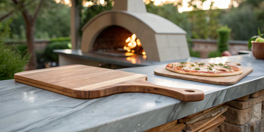 A wooden pizza peel, considered the best for launching pizza, next to an outdoor pizza oven.